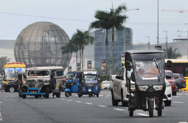 PHOTO: Electric tricycles, or e-trikes, and other unregulated electric vehicles like these seen near SM Mall of Asia inPasay City, are prohibited on major roads in the National Capital Region. STORY: MMC okays P2,500 fine to keep e-bikes, e-trikes off national roads