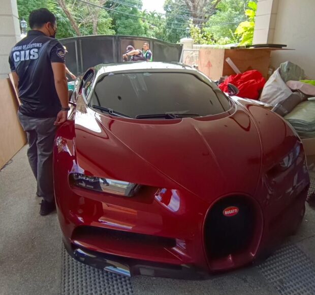 PHOTO: A customs official looks over a surrendered Bugatti Chiron. STORY: DOTr asks NBI for help in probe into ‘smuggled’ Bugatti cars